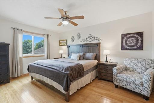 One of two spacious bedrooms, featuring a cooling ceiling fan and a walk-in closet with funcational double pocket doors. A comfortable and inviting retreat at the end of a long day.