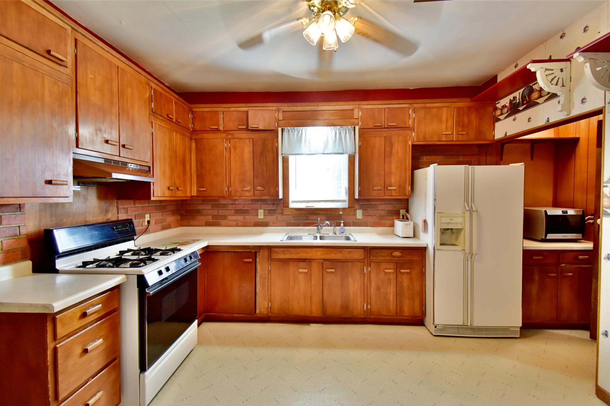 Kitchen has ample cupboards and counter area for family meals and entertaining