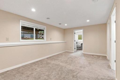 Spacious lower level family room with lookout windows and flexible space for relaxing, gathering, or entertaining.
