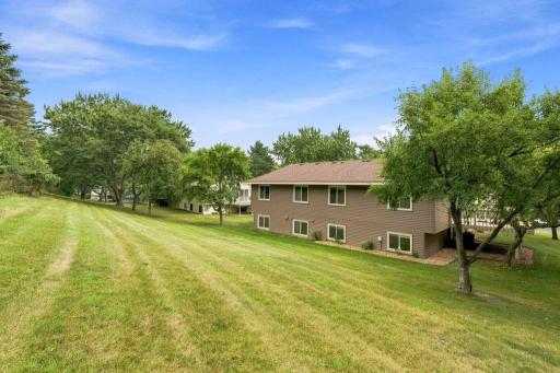 Spacious green surroundings and mature trees create a peaceful backdrop with room to enjoy the outdoors.