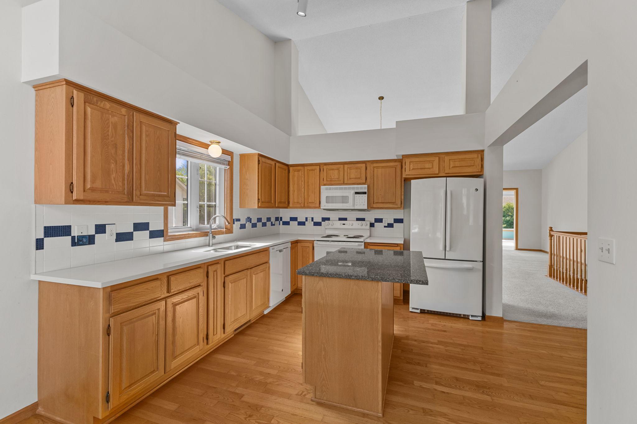 Functional kitchen offers generous cabinet space and a center island.