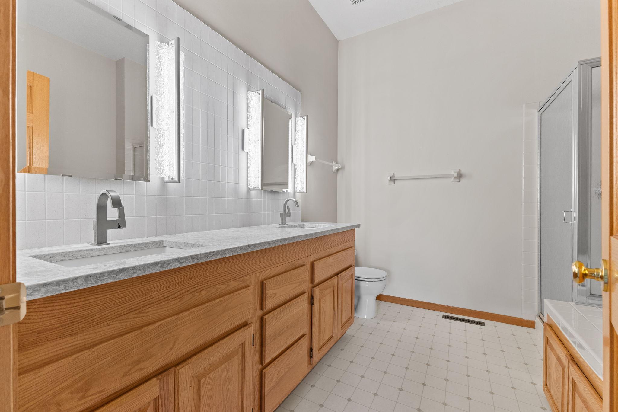 The primary bathroom offers dual sinks and a separate tub and shower.