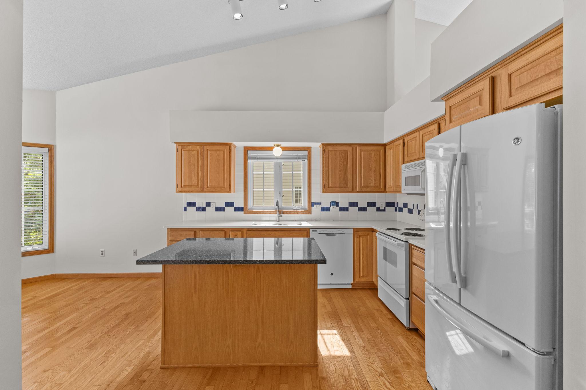 Spacious kitchen features a center island and abundant cabinetry.