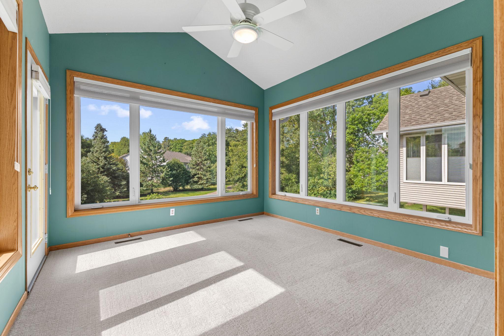 Transition into the sunroom with peaceful views of the surrounding greenery.