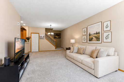 Newer carpet throughout the house - Living and Dining area (this photo contains digital staging elements)