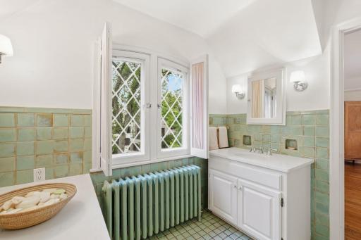 Fairy tale primary bath with amazing title, window with natural light! Newly updated vanities!