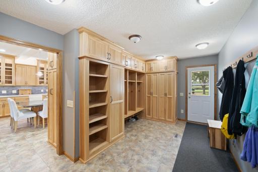 No detail left behind in this mudroom conveniently located off the garage. Access to front yard, laundry room, guest bathroom and kitchen
