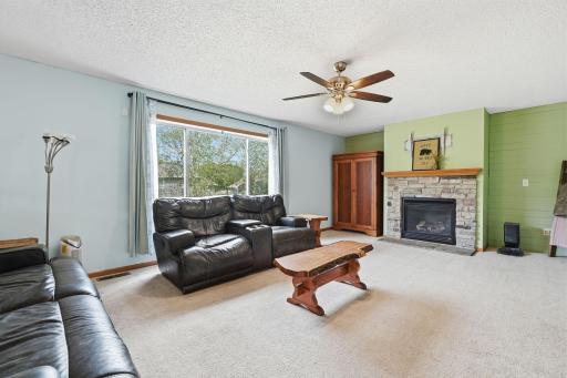 Enjoy the family room with a fireplace, windows out back, and just off the dining area.