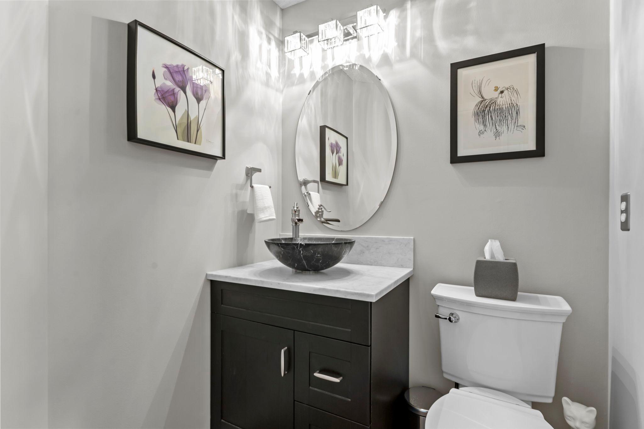 The stylish main level 1/2 bathroom.