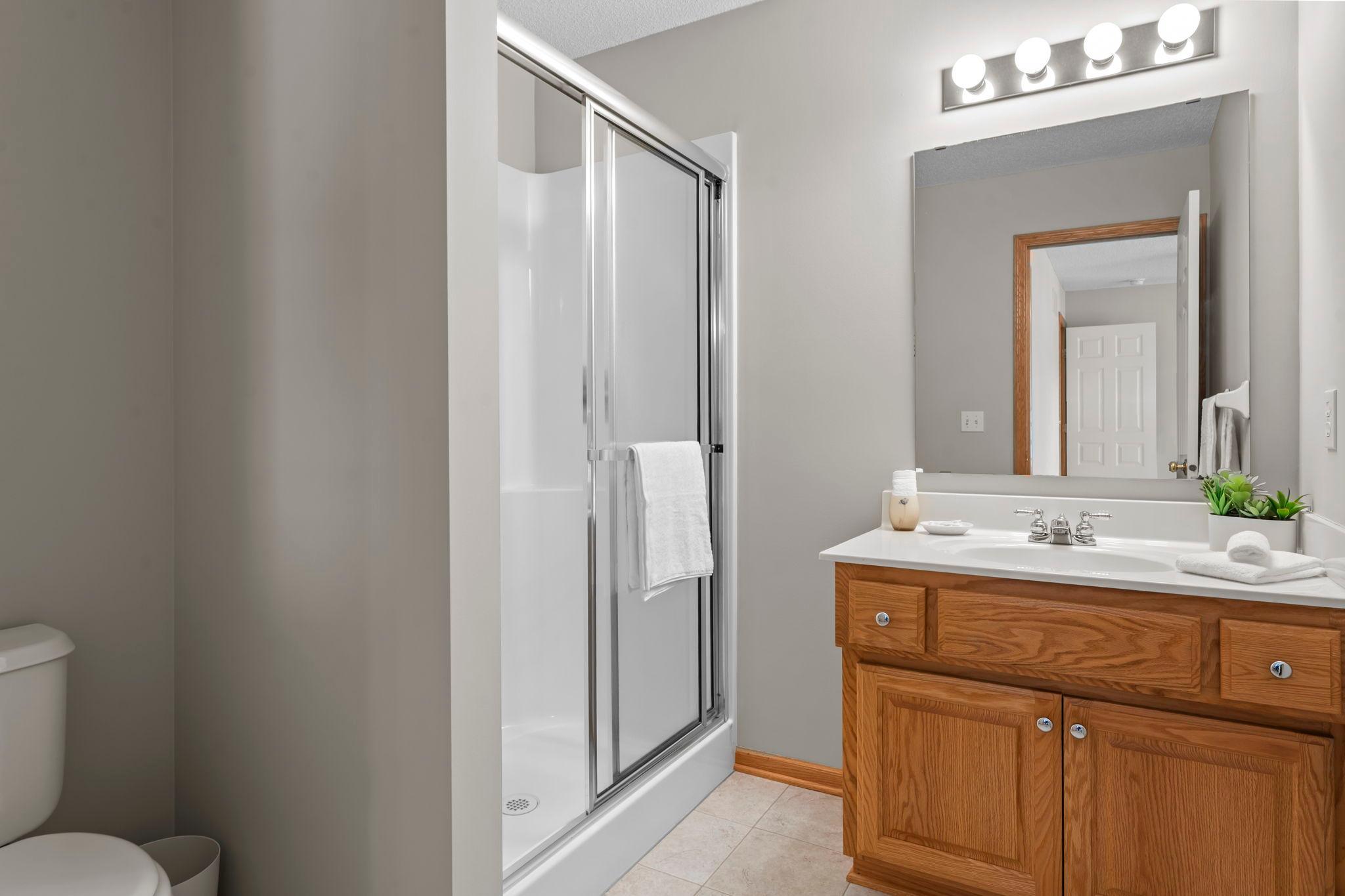 The private ¾ bathroom offers a walk-in shower and single vanity