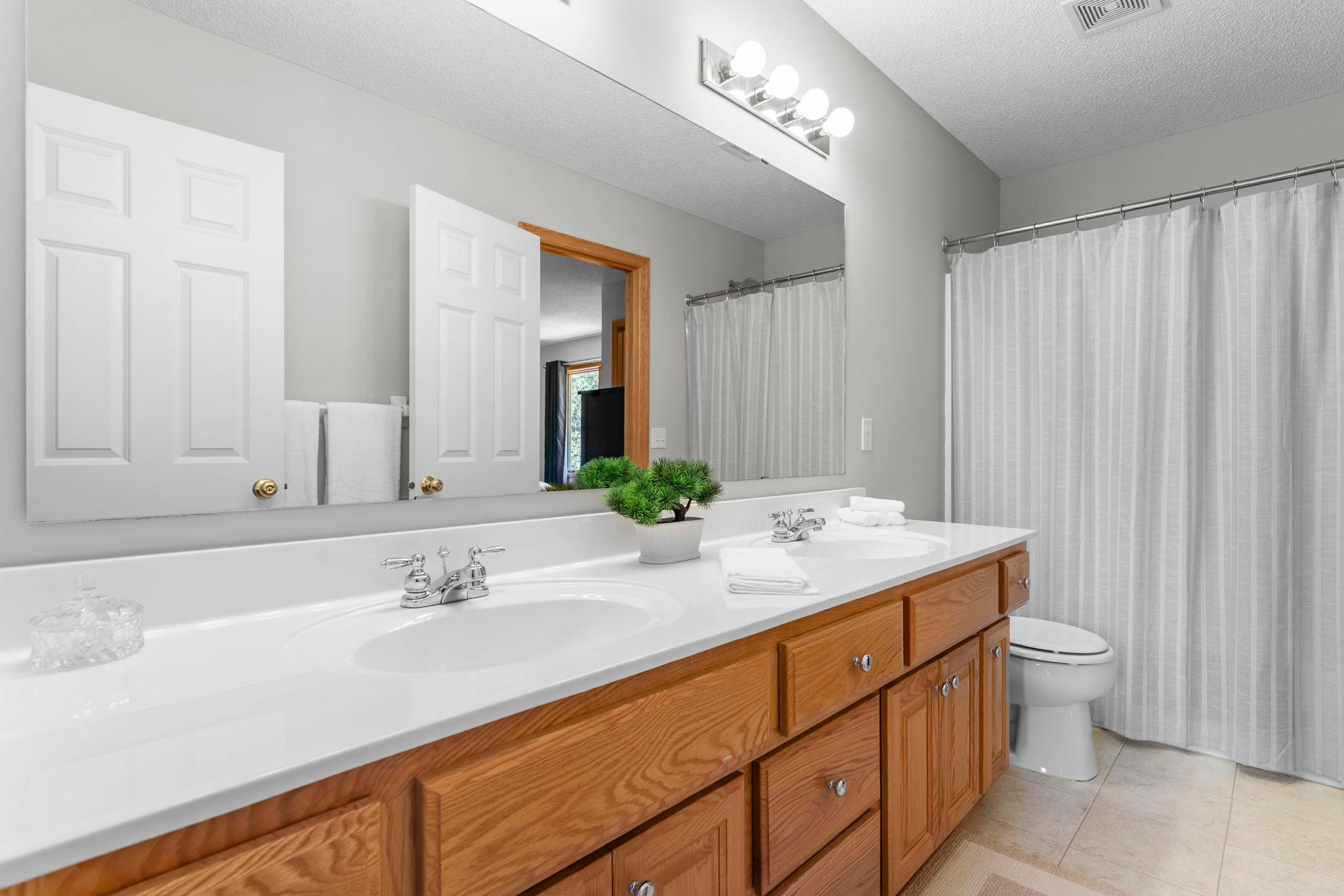 The shared Jack-and-Jill full bathroom with dual vanities and a tub/shower combination.