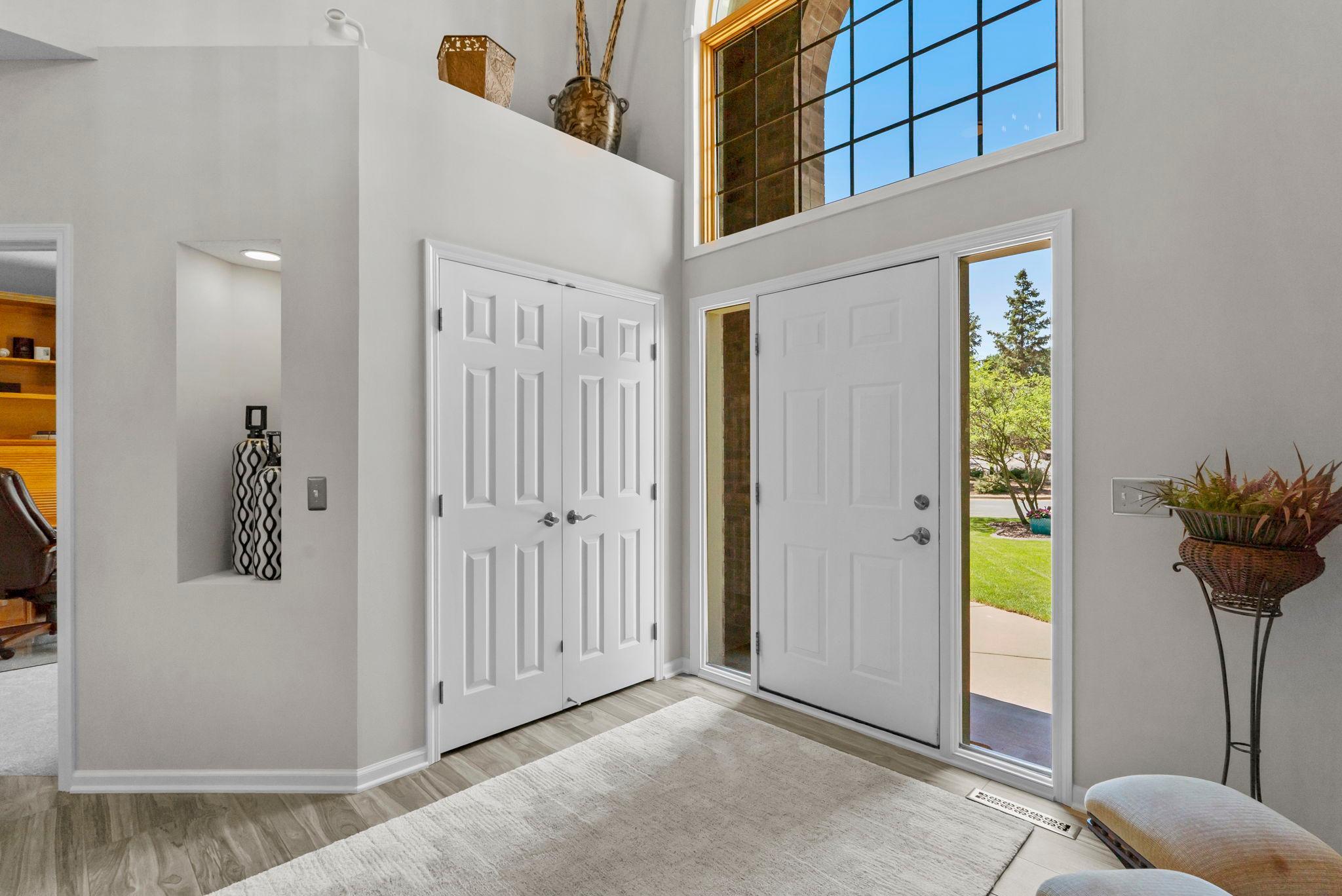 Flanking the foyer are a cozy sitting room and a well-appointed office or den.