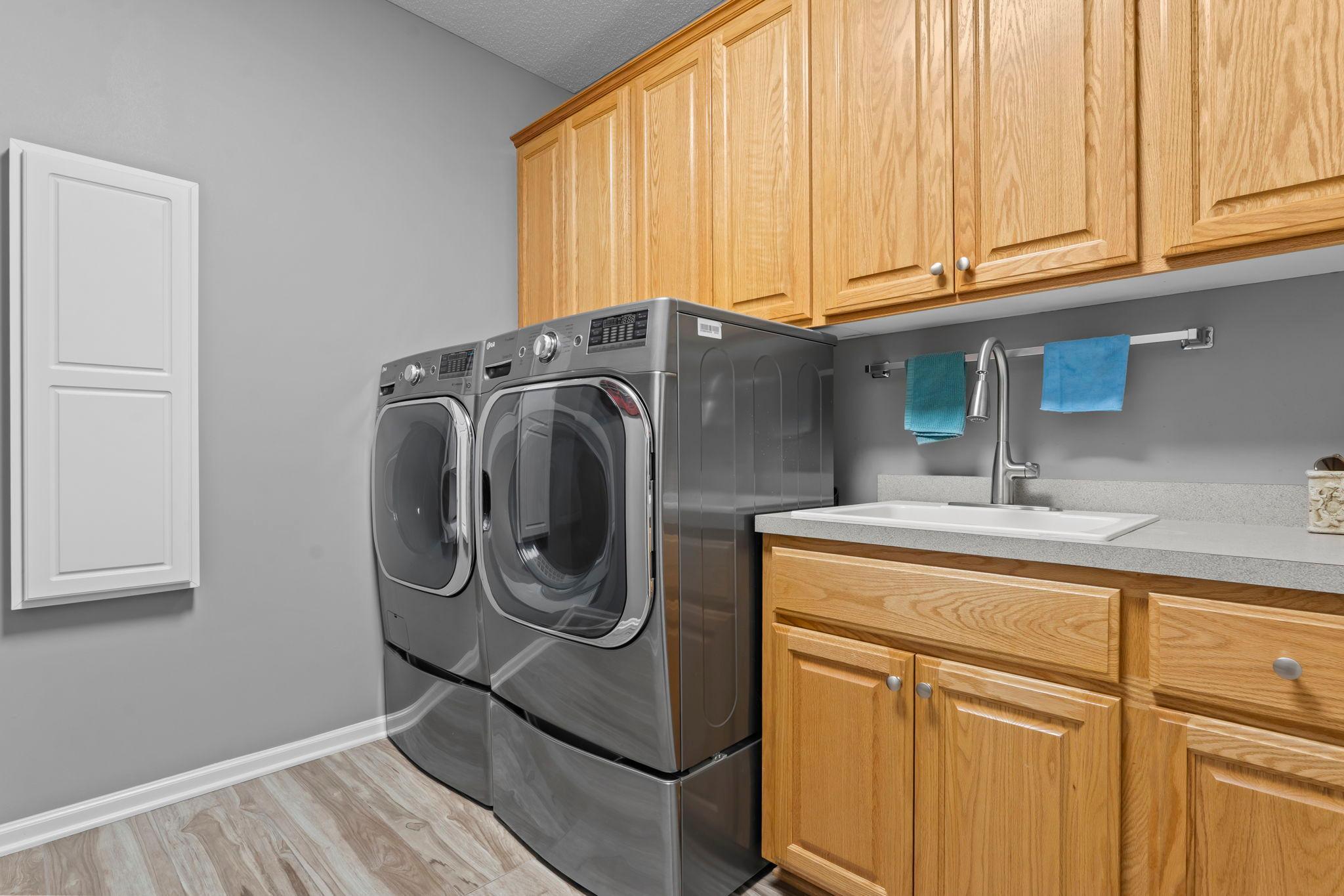 The main level is completed by a well-appointed laundry room, convenient nearby half bathroom, and easy entry from the oversized, heated 3-car garage.