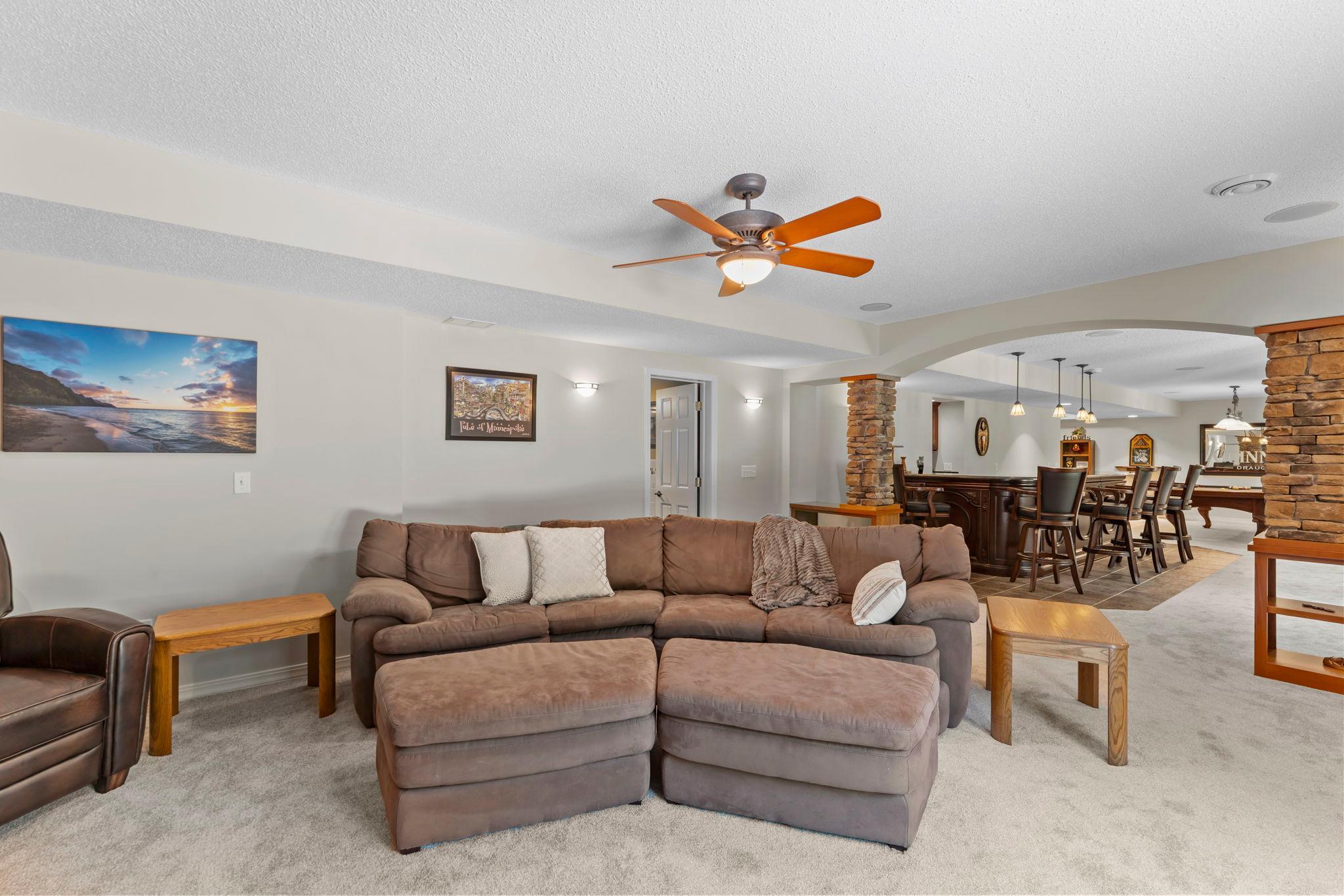 An alternate perspective of the family room, showcasing views of the open-concept lower-level entertainment space.