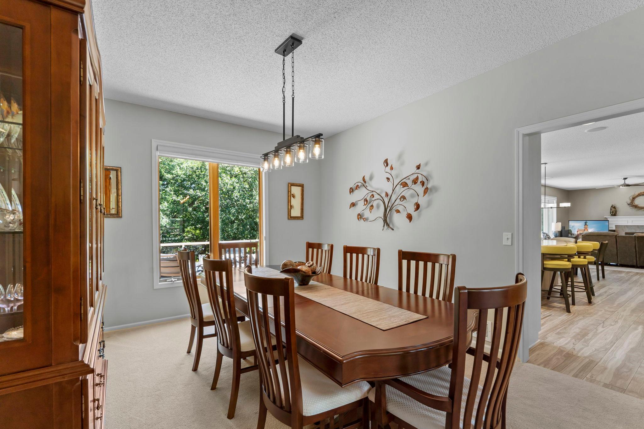 For more formal gatherings, the formal dining room is conveniently located off both the kitchen and front sitting room and features carpeting, a classic light fixture, and large rear-facing windows.