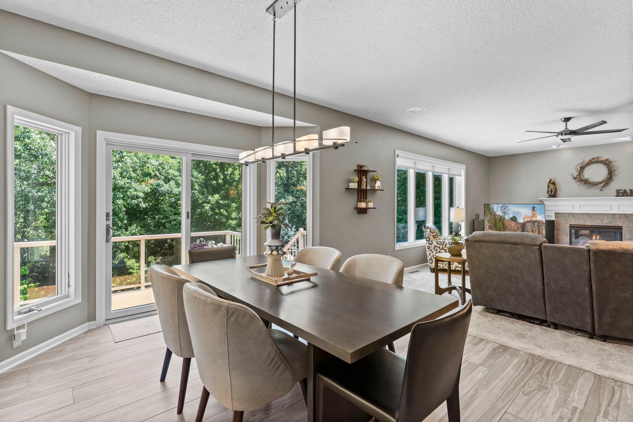 The informal dining area provides a welcoming space for everyday meals and features Anderson sliding doors, replaced in 2023, that open directly to the spacious maintenance-free deck.