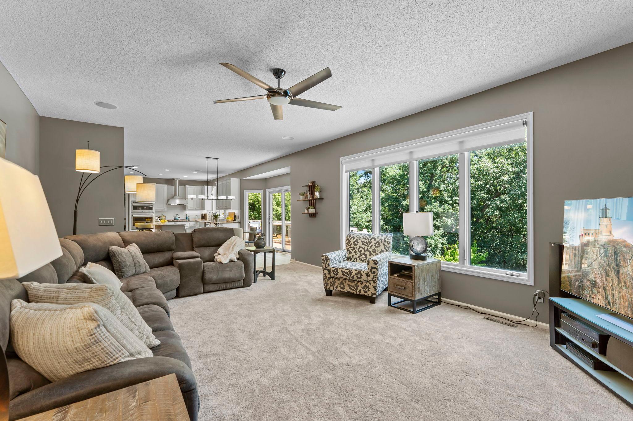 A different angle of the living room, showcasing the abundance of natural light and open-concept floor plan.