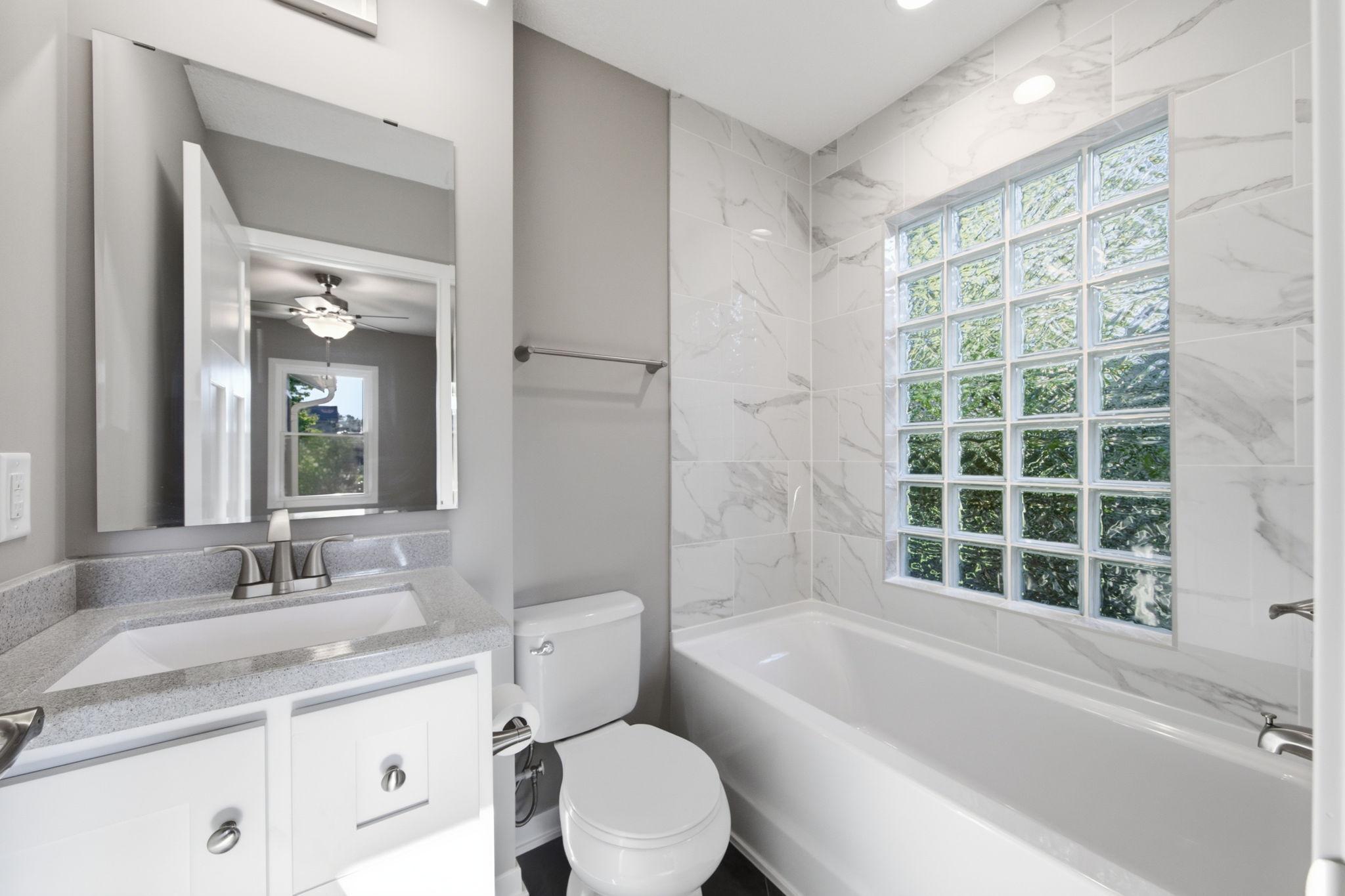 Primary Bathroom lets in natural light and offers privacy