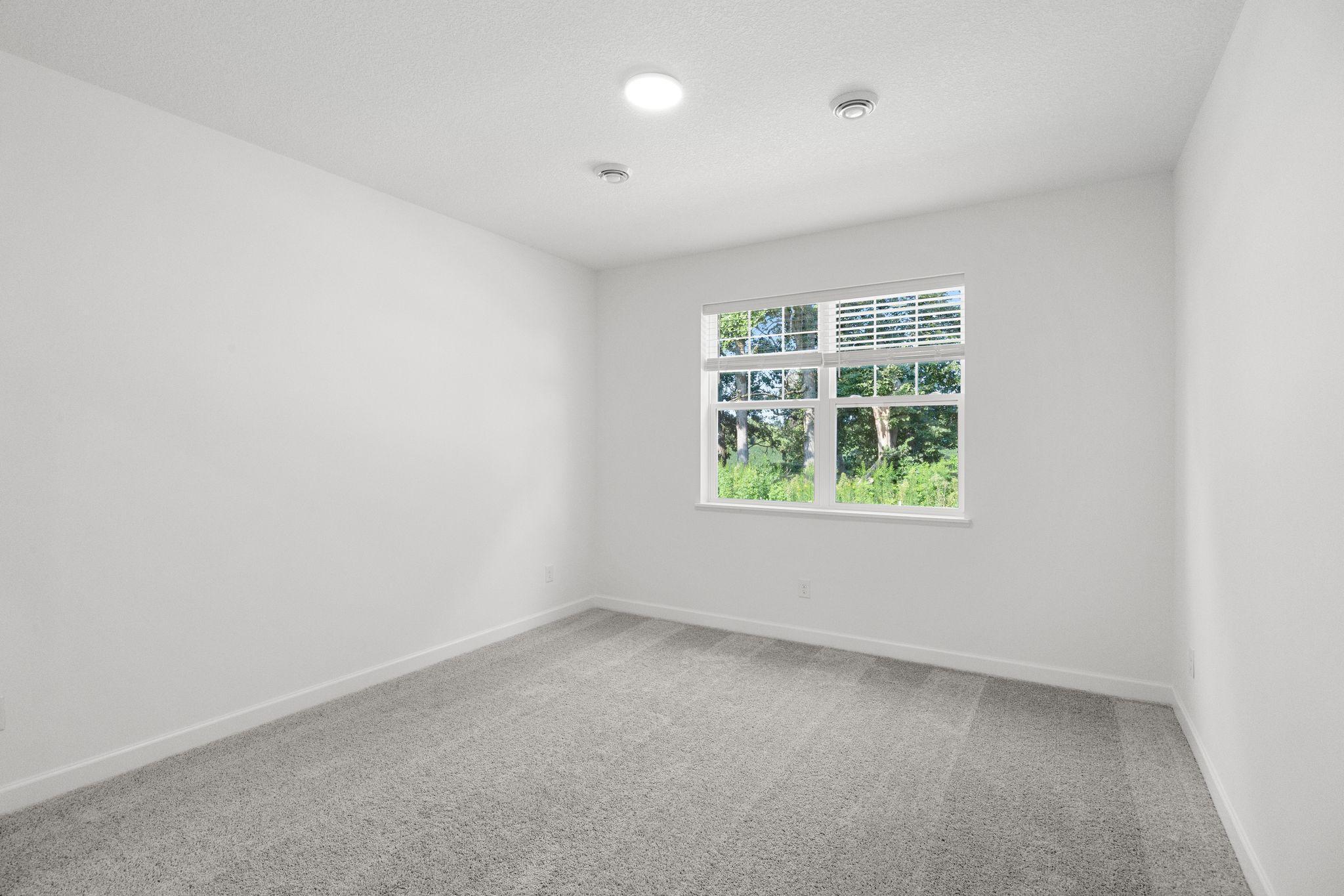 Found at the back of the home for privacy, the owner’s suite is a comfortable and restful space featuring an en-suite bathroom and a walk-in closet.