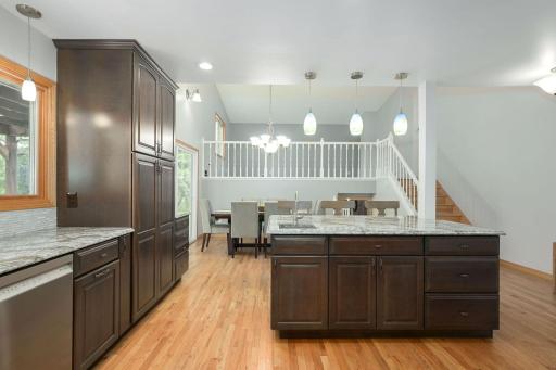 The Kitchen flows to the 2 story dining area and upper-level Living Room