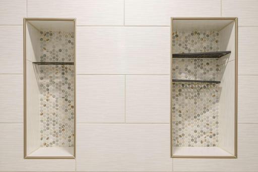 Detailed tiled shelving in walk-in shower