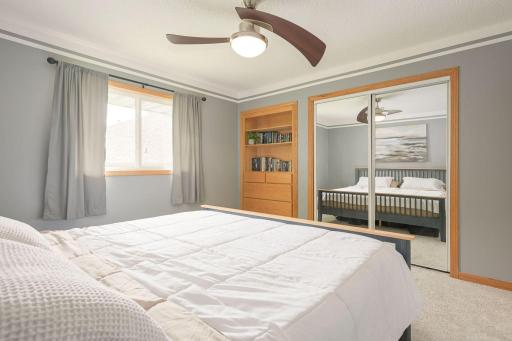 Upper-level 3rd Bedroom with built-in shelving and mirrored closet