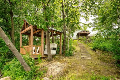 Another view of the lake gazebo and stairs leading up to the backyard