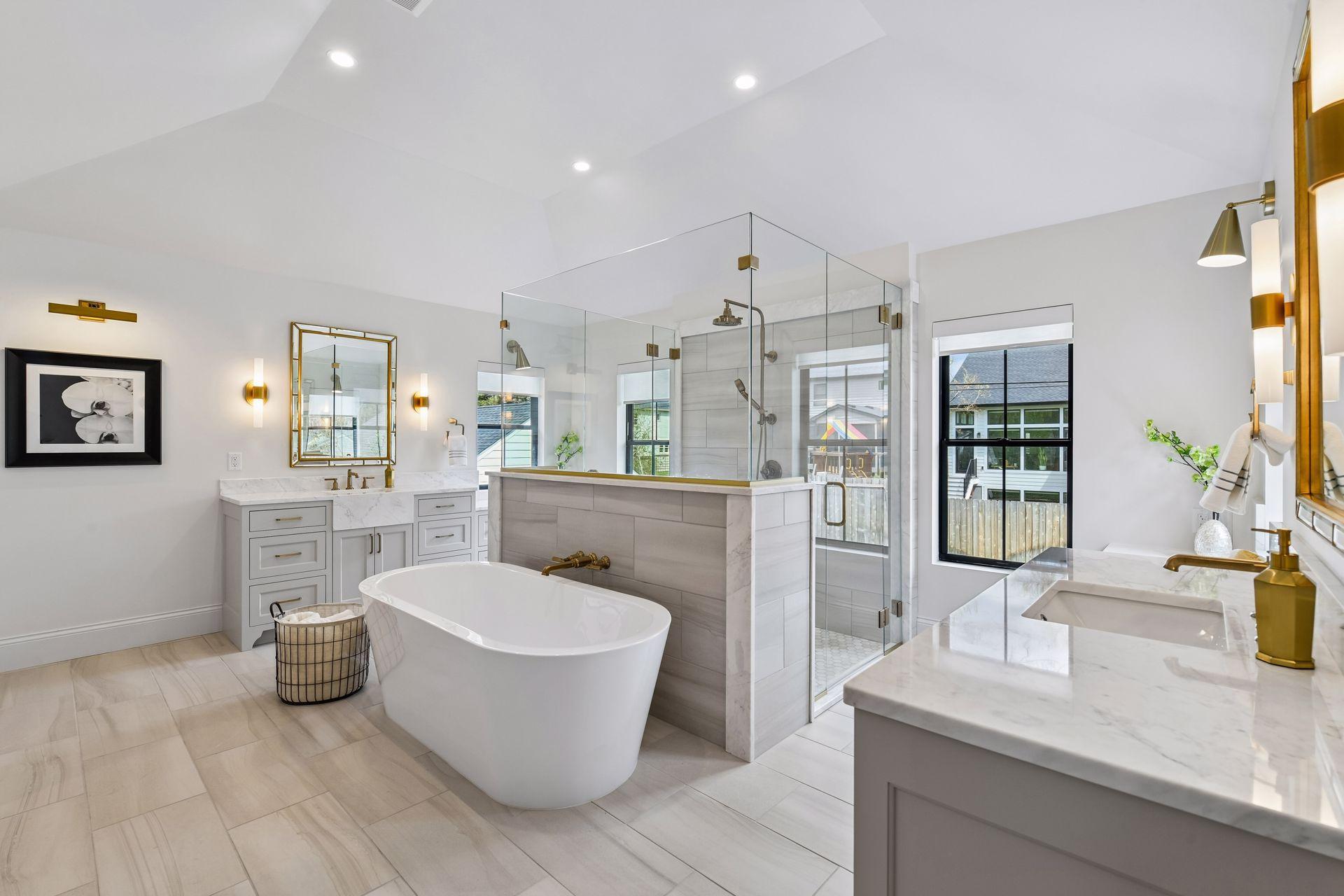 Primary bathroom retreat features in floor heat, free standing soaking tub and walk through tiled shower