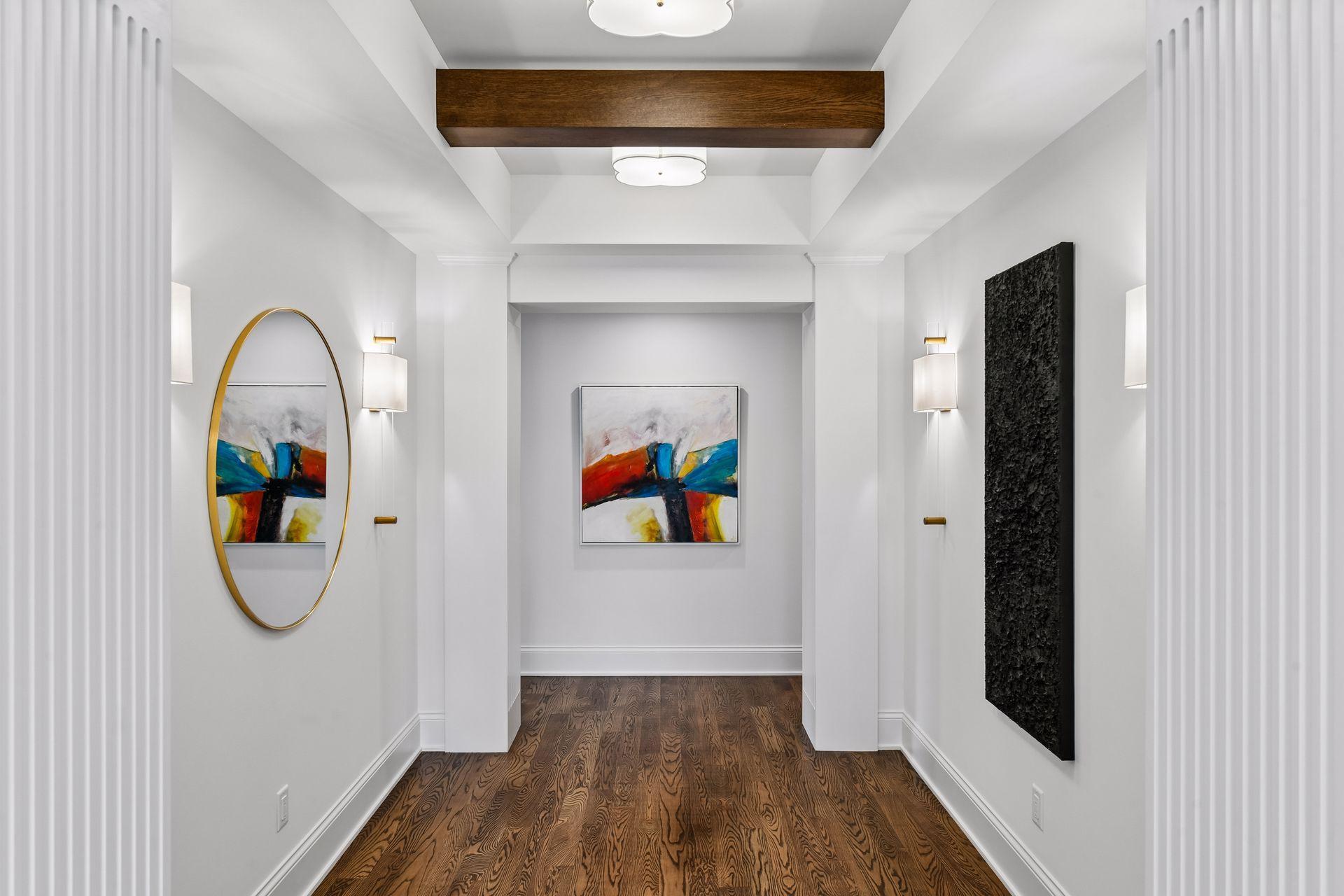 Upstairs landing features sconce lighting and beams throughout making this a standout