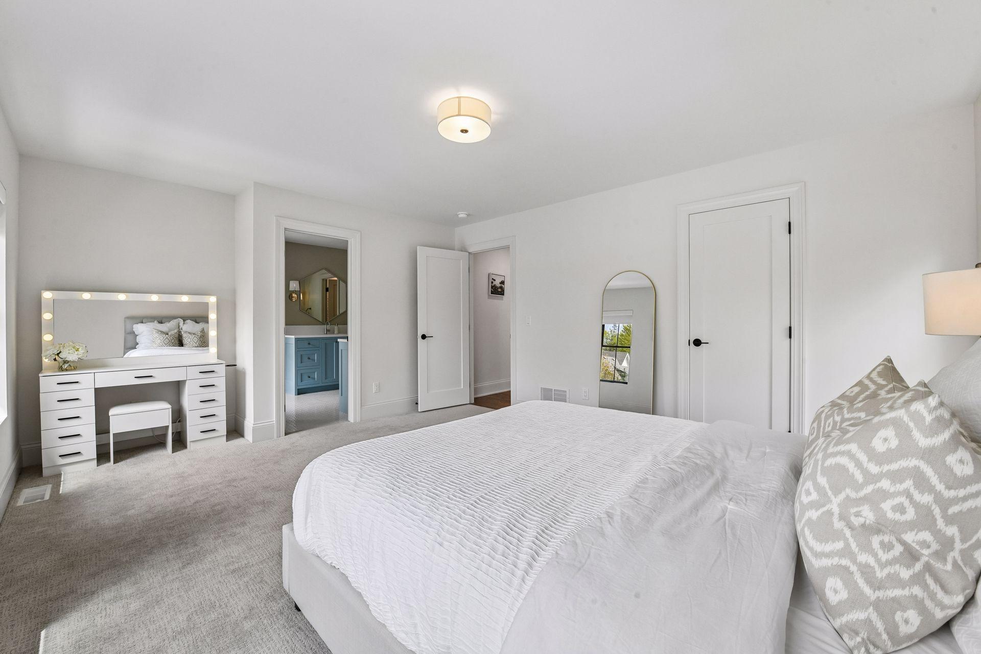 Spacious jack and Jill bedrooms each feature privacy shades walk in closets with custom closet systems