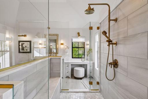 Primary bathroom retreat features in floor heat, free standing soaking tub and walk through tiled shower