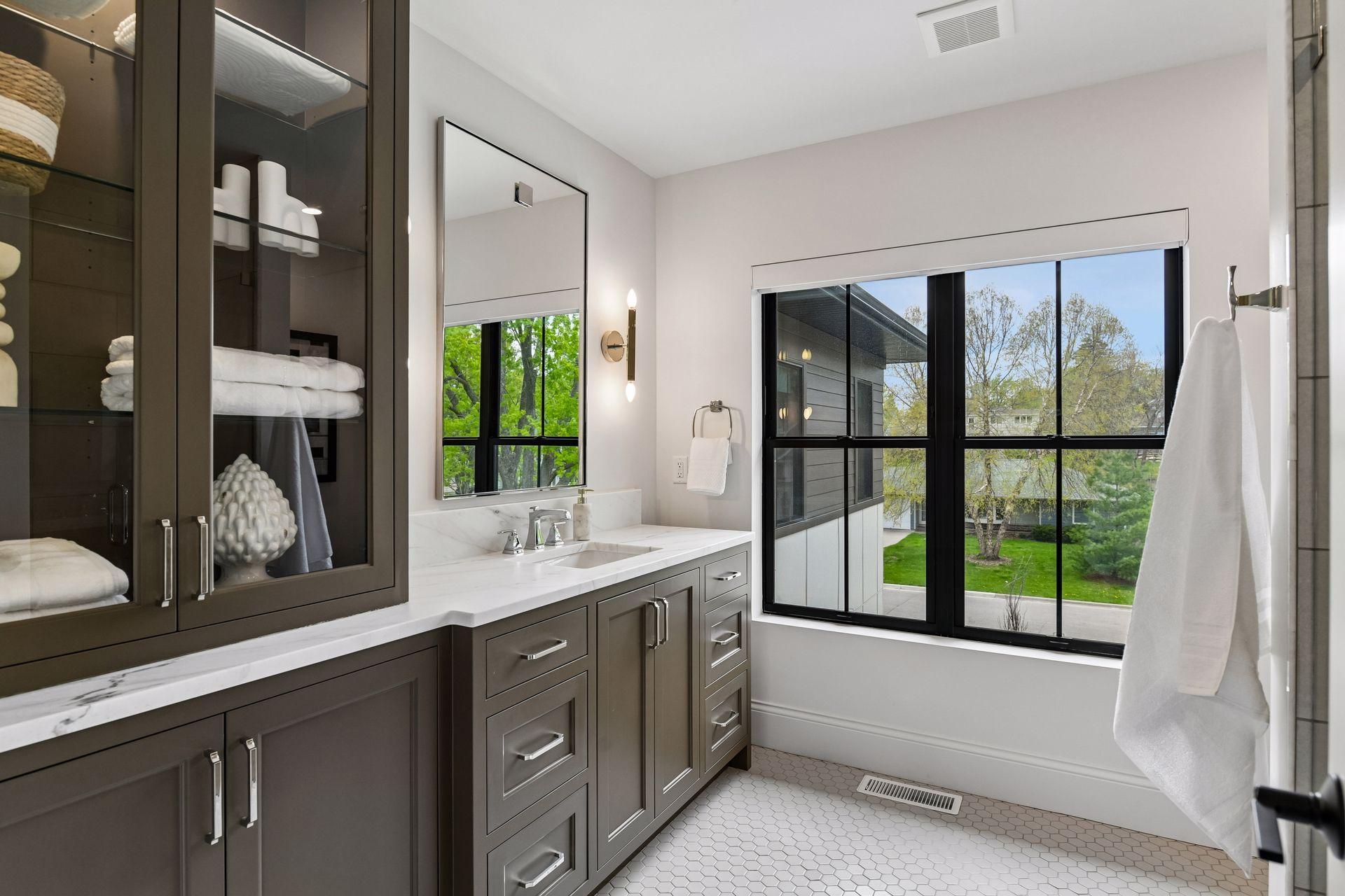 Ensuite bathroom with custom cabinetry and tiled walk in shower