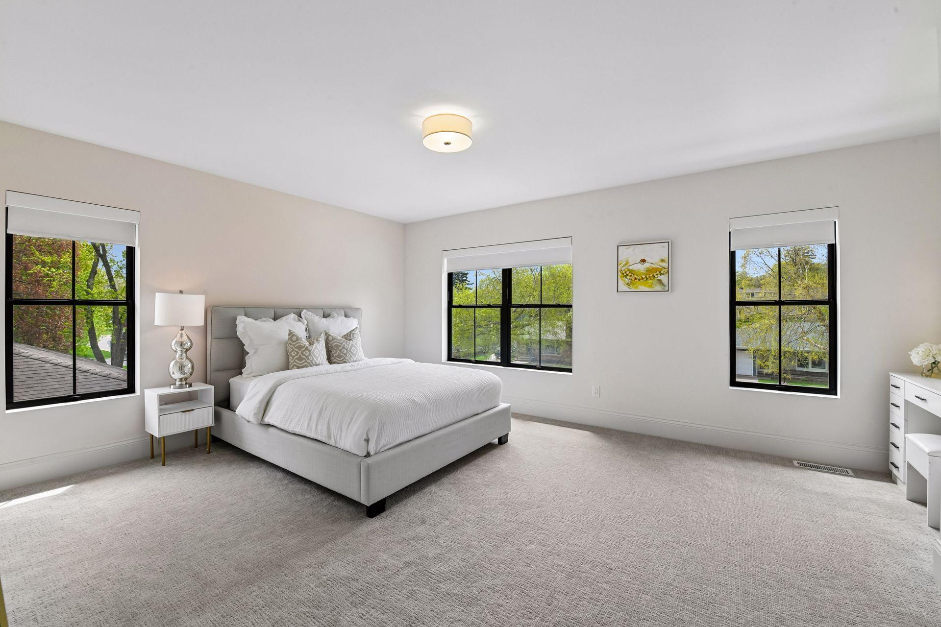 Spacious jack and Jill bedrooms each feature privacy shades walk in closets with custom closet systems