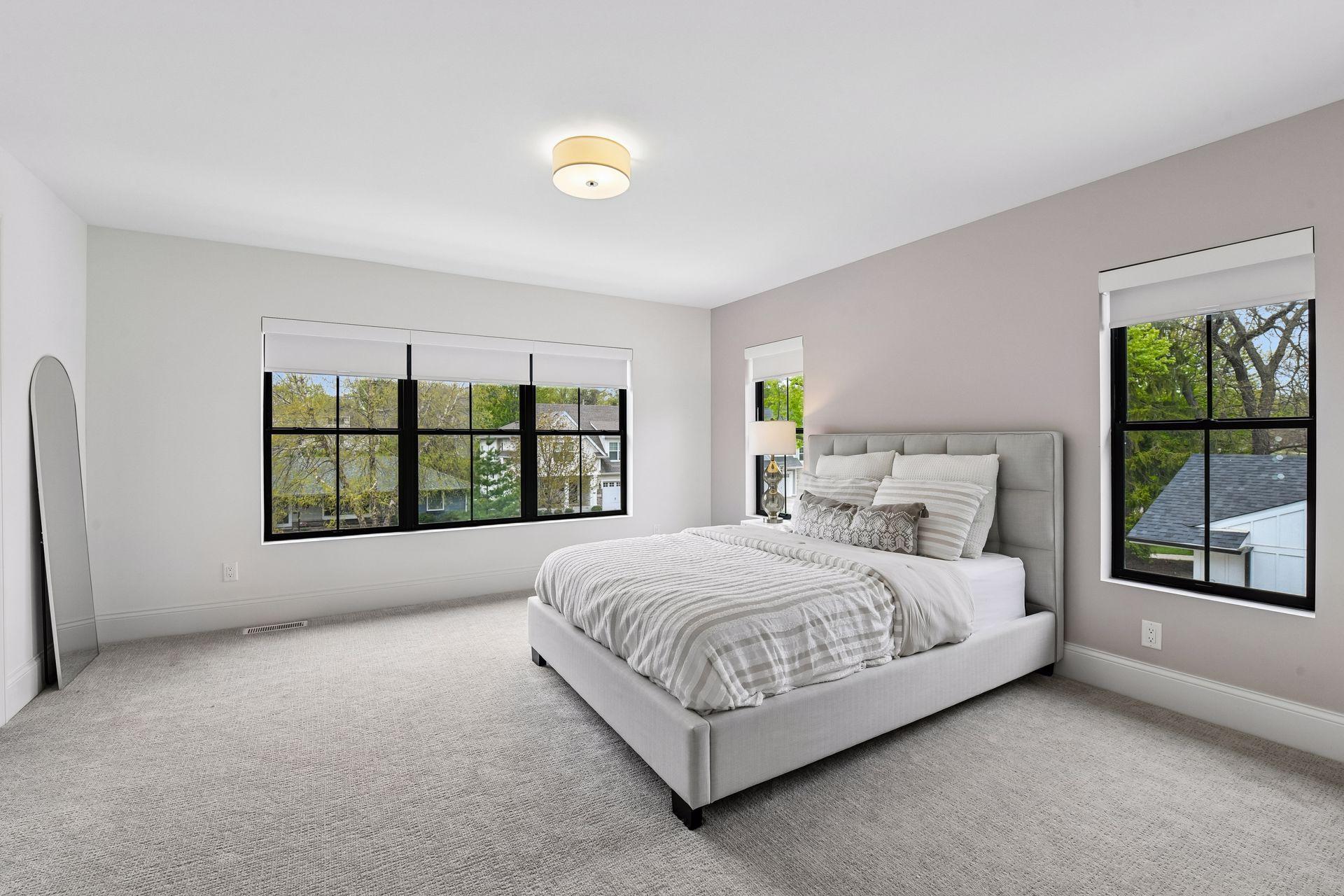 Spacious jack and Jill bedrooms each feature privacy shades walk in closets with custom closet systems