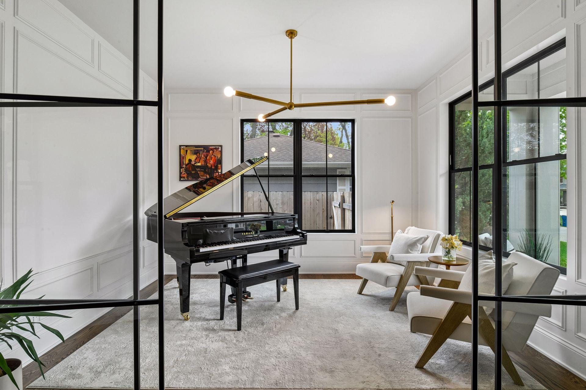 Front office space with floor to ceiling glass panels, custom lighting is perfect for a home office or formal seating