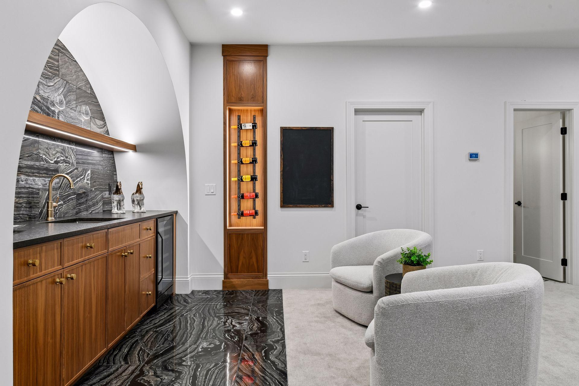 Lower level built in bar features built in wine cooler and backlit wine display