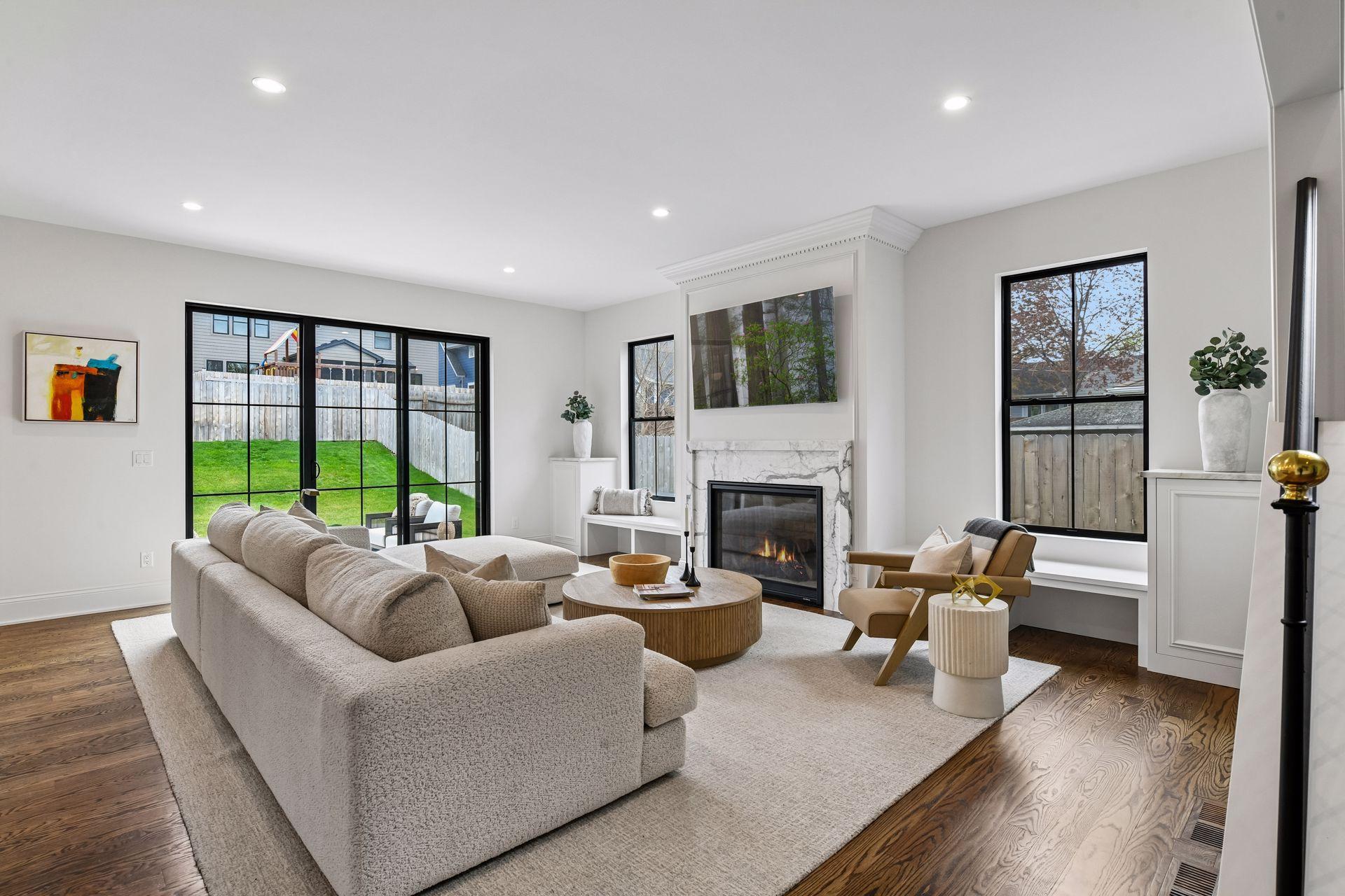 Large main level living room with floor to ceiling sliding glass doors that lead directly to backyard