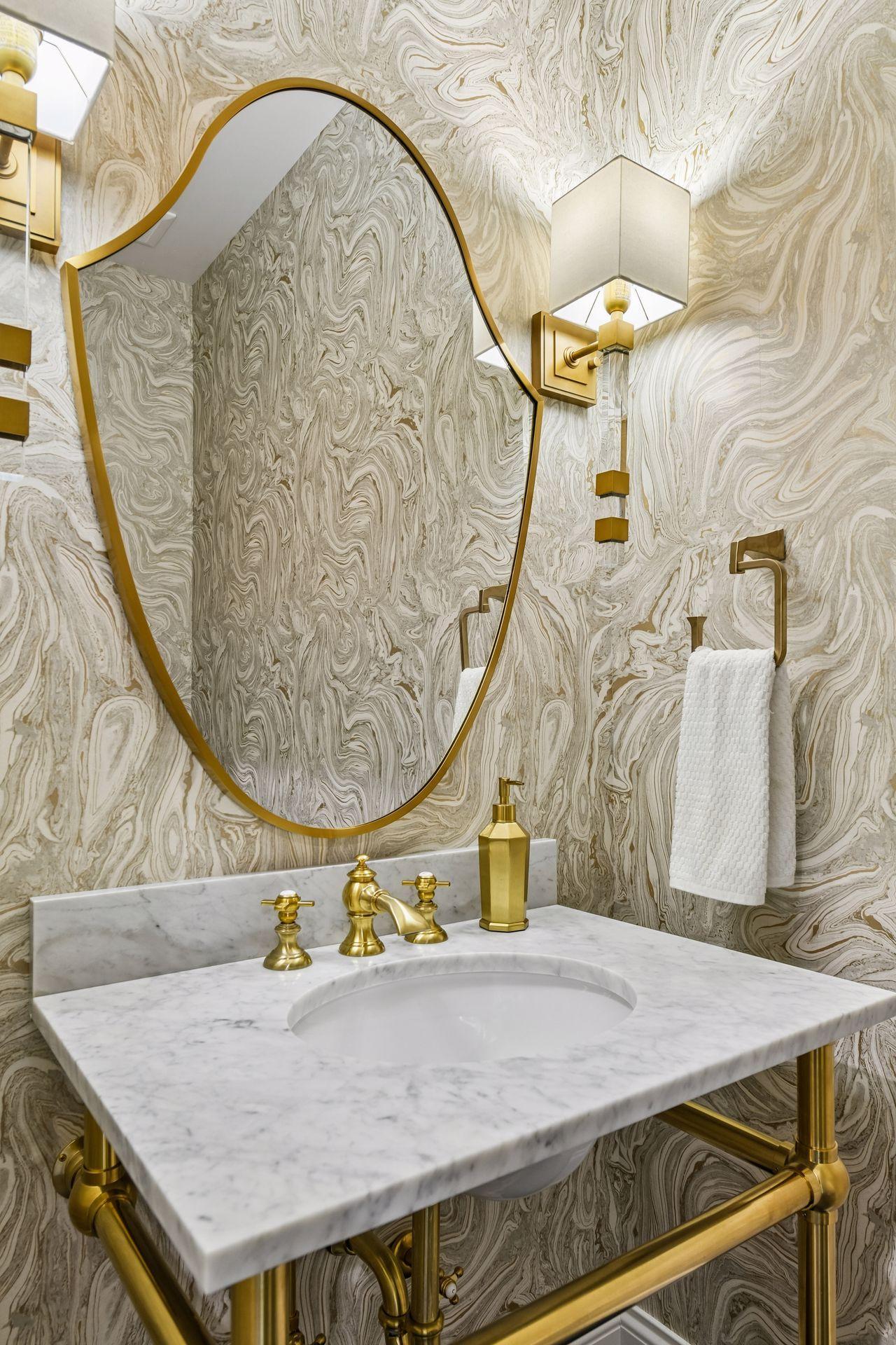 Half bathroom on the main level with brizo fixtures and custom wall paper