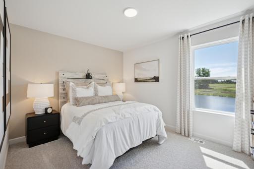 (Photo of a model home, finishes will vary) Two secondary bedrooms are located on the main level, along with the owner’s suite, providing peaceful havens.