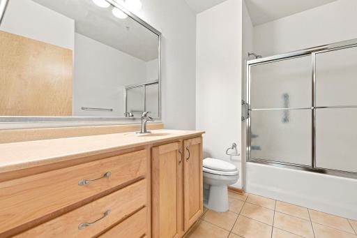 Full bath. stacked washer and dryer are in the closet behind the door