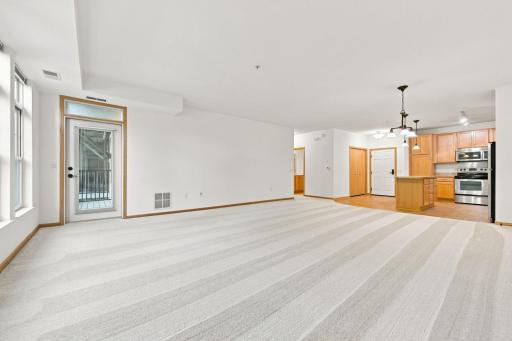 view from the living room toward the kitchen and front door