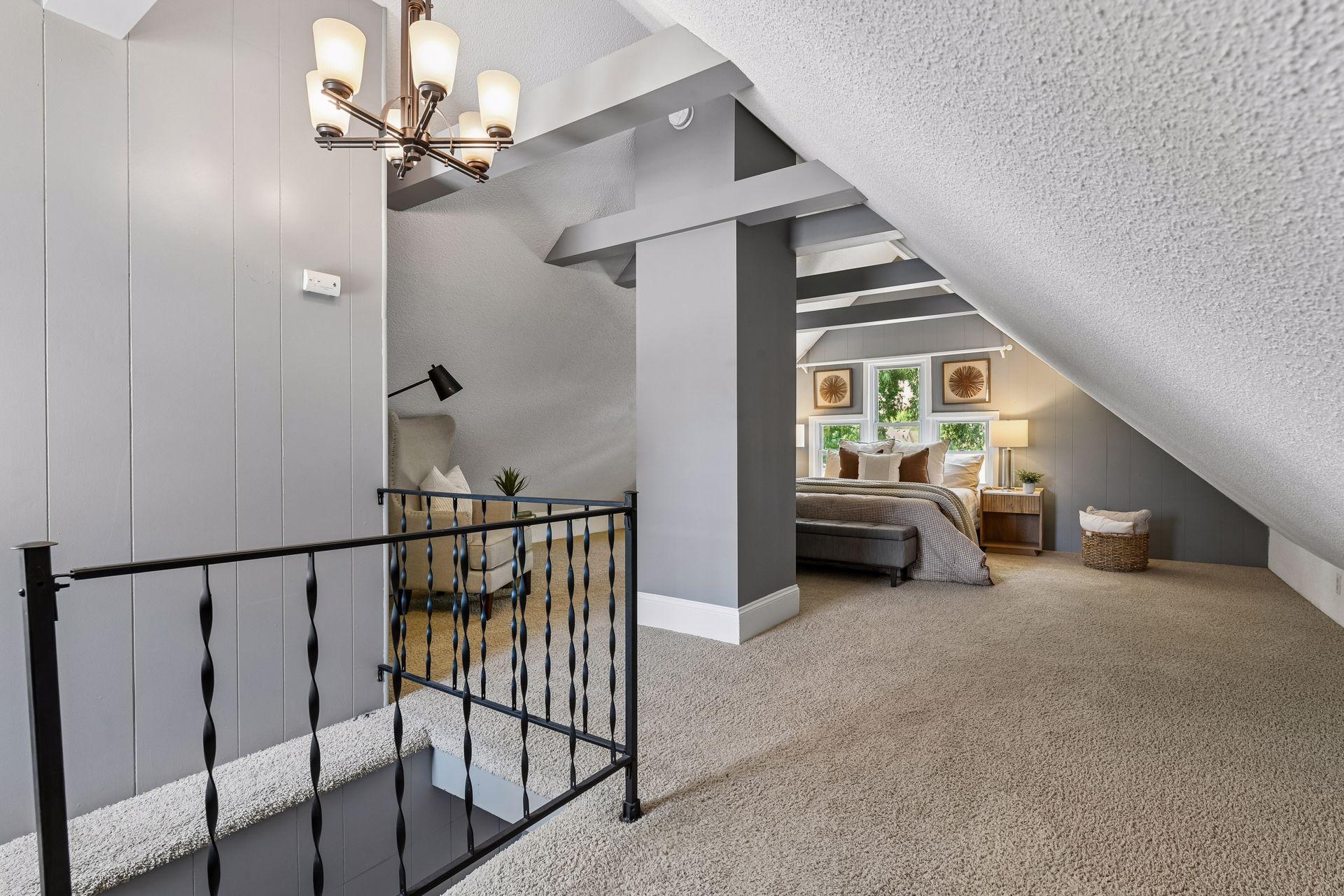 Upstairs, the spacious bedroom features vaulted ceilings and a walk-in closet.