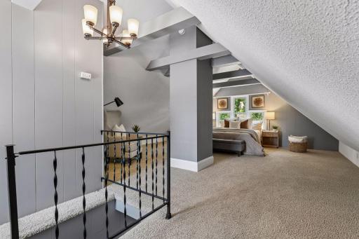 Upstairs, the spacious bedroom features vaulted ceilings and a walk-in closet.