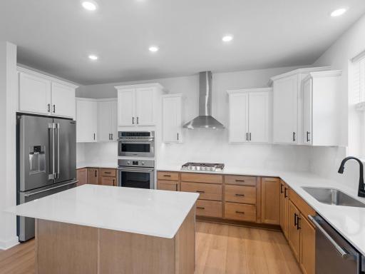 The center island extends out to a breakfast bar for casual meals