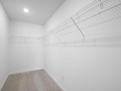 Accessible from the primary bedroom, this large walk-in closet provides abundant storage space for growing wardrobes