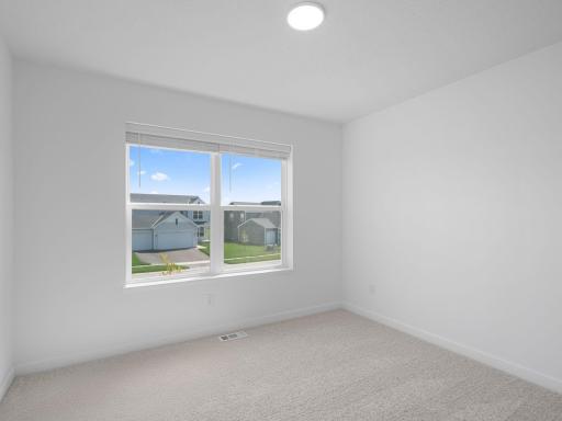 Three secondary bedrooms are located on the second level.
