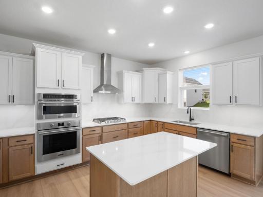 This modern kitchen features a set of brand-new stainless steel appliances, abundant cabinet space and a convenient center island to add seating and counter room.