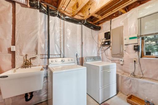 Lower level laundry with a utility sink.