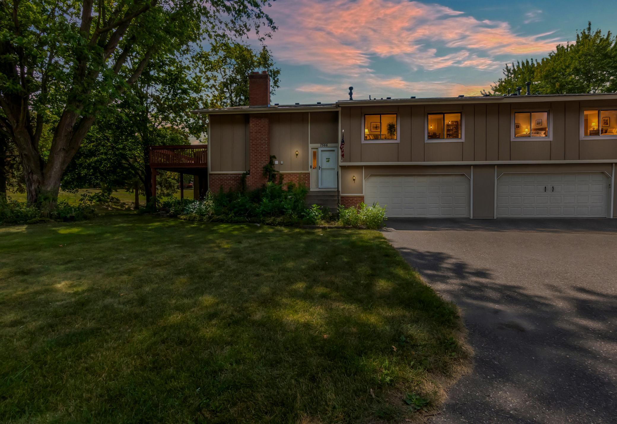 Welcome to 7566 E Fish Lake Rd! A charming split-level property nestled on a spacious, tree-lined lot.