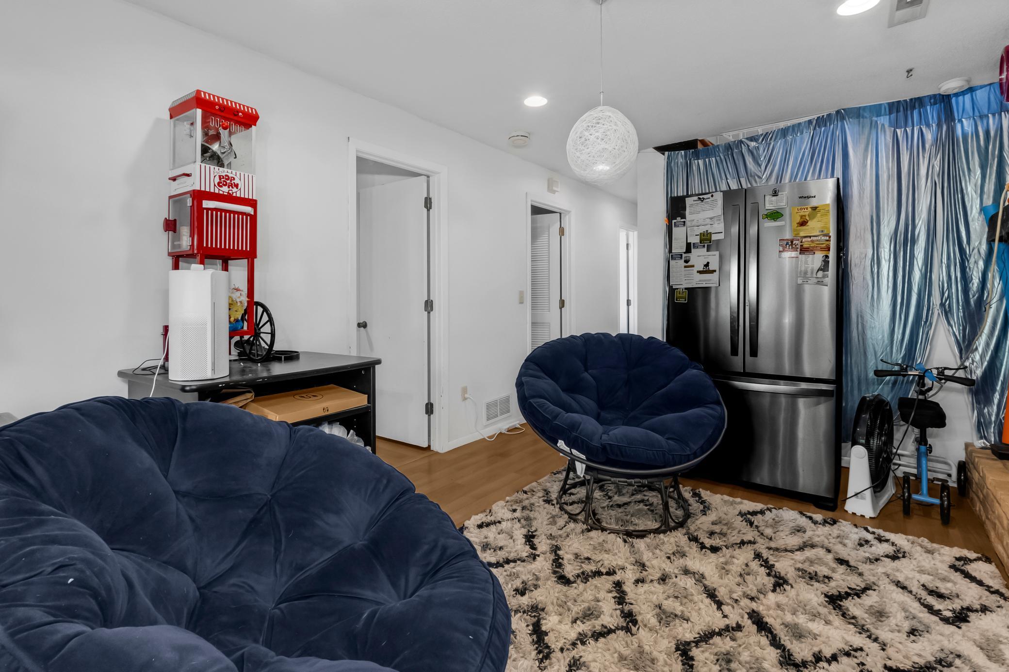 Versatile living space with rich wood tones, perfect for an entertainment room or lounge area.